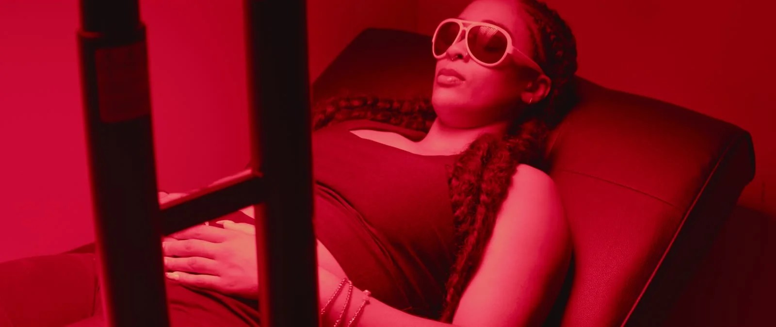 A member relaxing under red light therapy in the recovery lab
